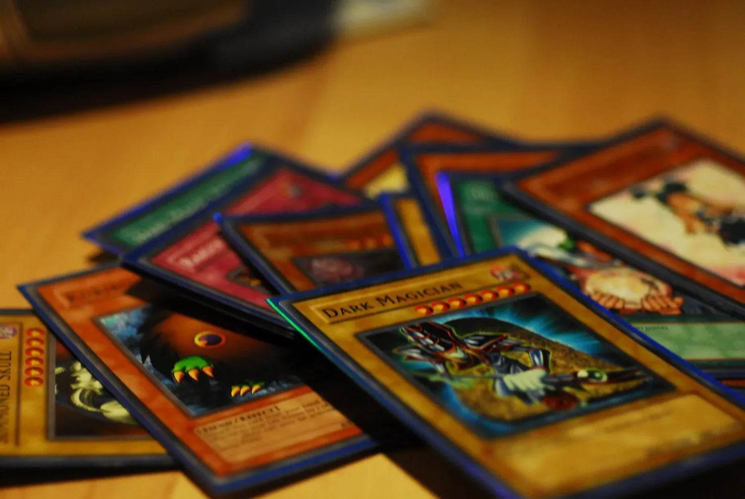 Yu-Gi-Oh! cards fanned out on a wooden table